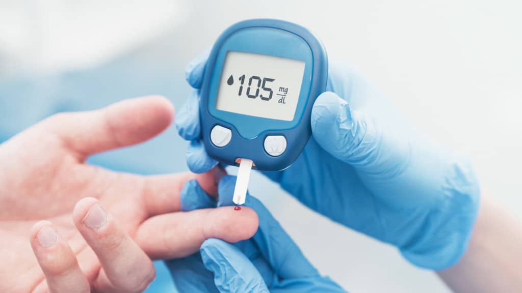 glucometer and person checking blood sugar level