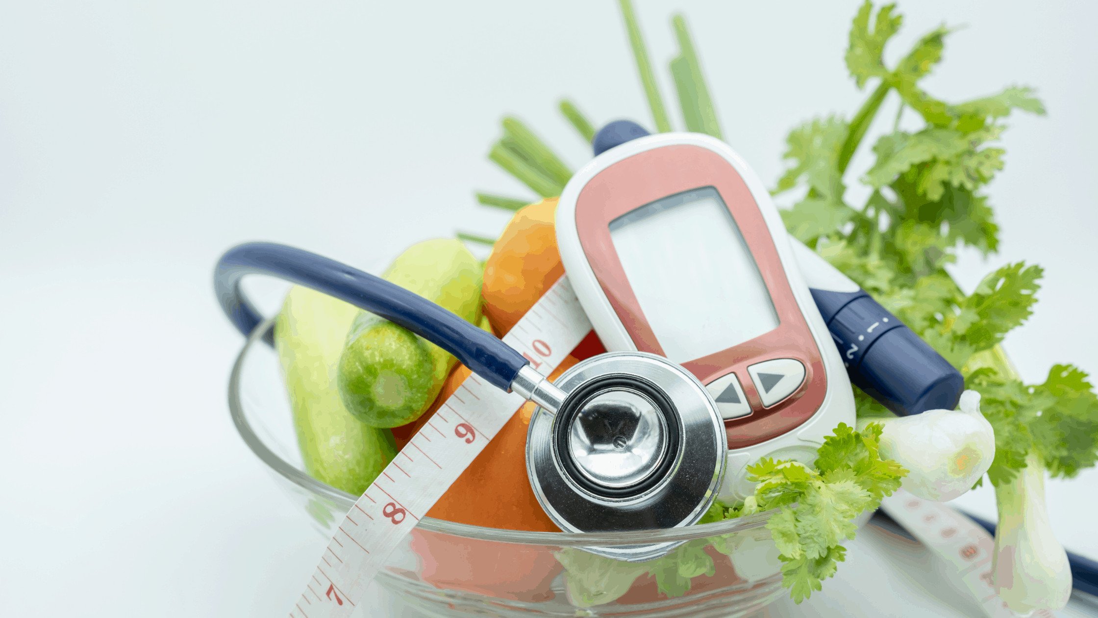 11bowl of veggies with glucometer, stethoscope, and tape measure - manage diabetes