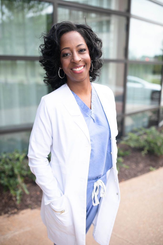 Dr. Nicolle standing in white coat