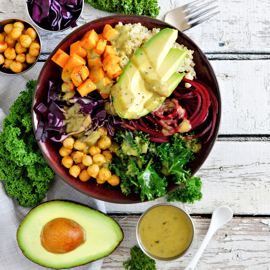 11Buddha Bowl with Quinoa, Avocado, Chickpeas, Vegetables on a White Wood Background, Healthy Food Concept. Top View, Side Border with Copy Space