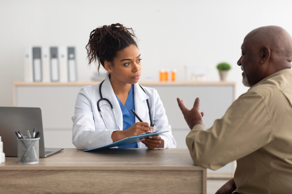 Young black doctor explaining treatment plan to male patient